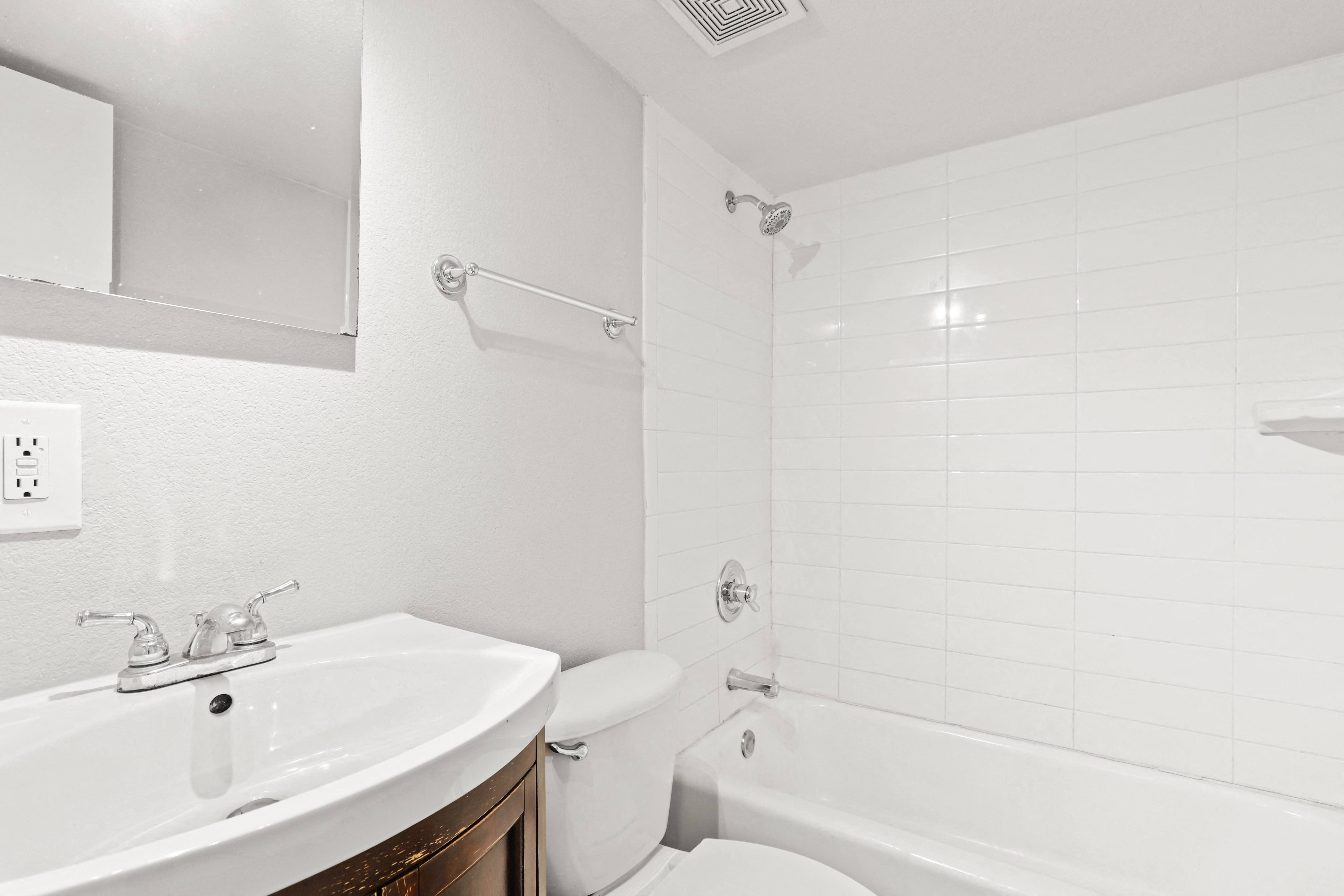a bathroom with a sink and a toilet and a tub